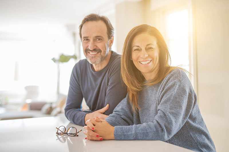 Parents lean against the kitchen counter Parents lean against the kitchen counter